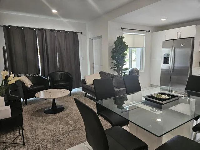 a living room with furniture rug and window
