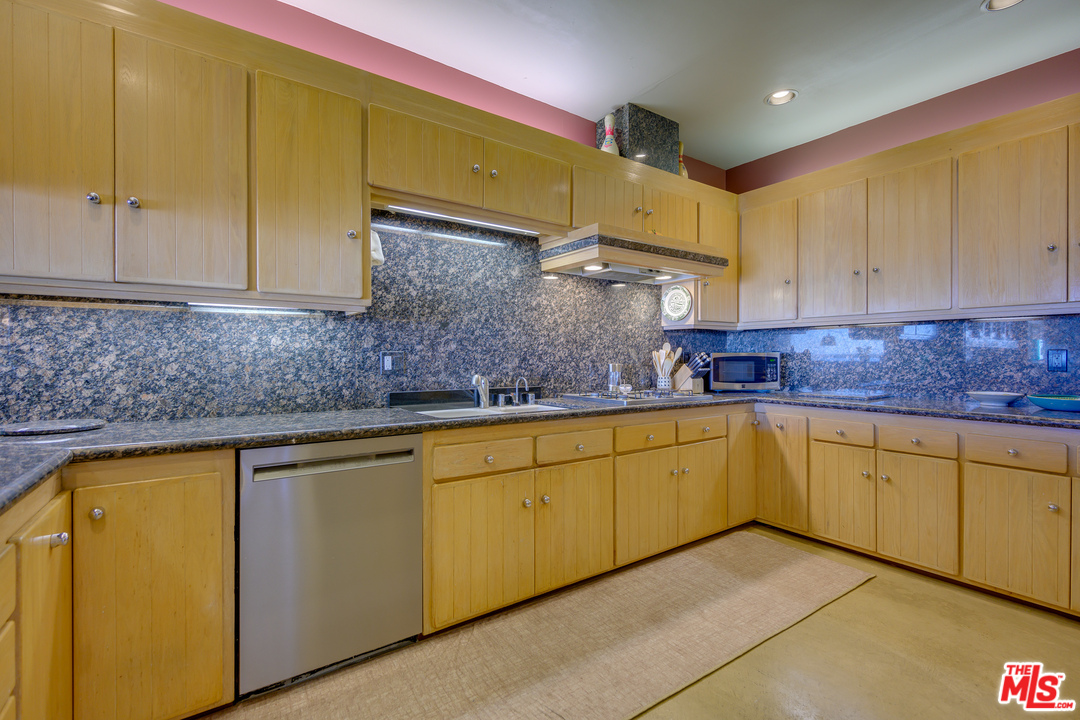 1 Spinnaker Street, Unit 2 Marina del Rey, CA 90292 - Photo 15 of 33 a kitchen with stainless steel appliances granite countertop a sink a stove cabinets and entryway