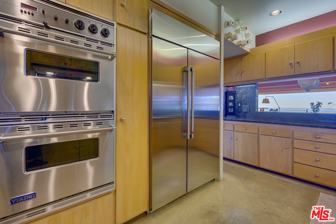 1 Spinnaker Street, Unit 2 Marina del Rey, CA 90292 - Photo 16 of 33 a kitchen with granite countertop stainless steel appliances and wooden cabinets