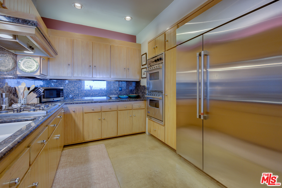 1 Spinnaker Street, Unit 2 Marina del Rey, CA 90292 - Photo 17 of 33 a kitchen with stainless steel appliances granite countertop a sink and cabinets
