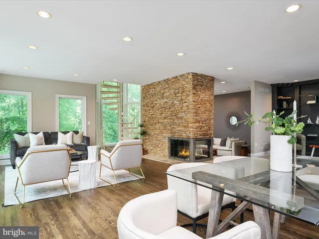 a living room with furniture a rug and a large window