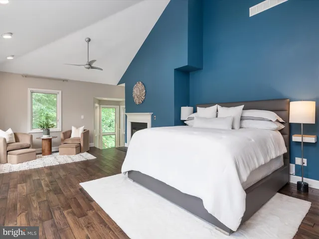 a view of a balcony with chairs and wooden fence