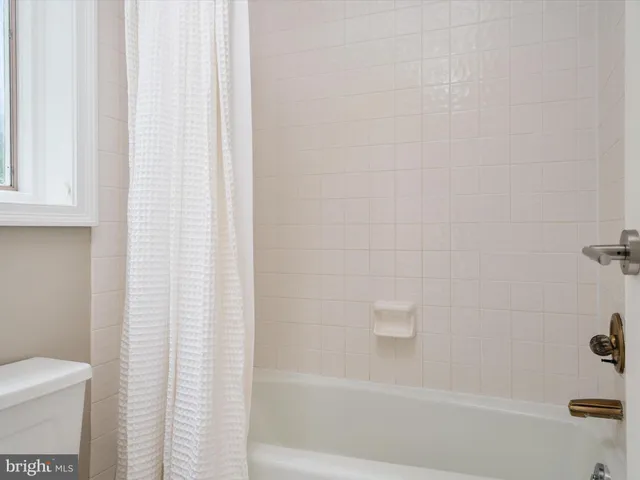 an aerial view of green landscape with trees houses and lake view