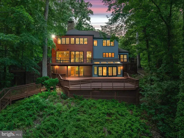 a living room with furniture and floor to ceiling windows