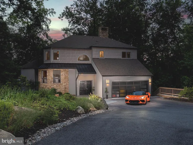 a living room with fireplace furniture and a large window