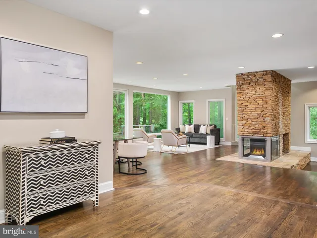 a living room with a couch and a potted plant