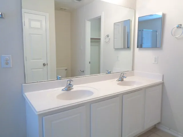 a bathroom with a granite countertop sink