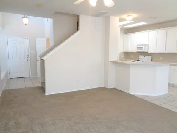a bathroom with a granite countertop toilet and a sink