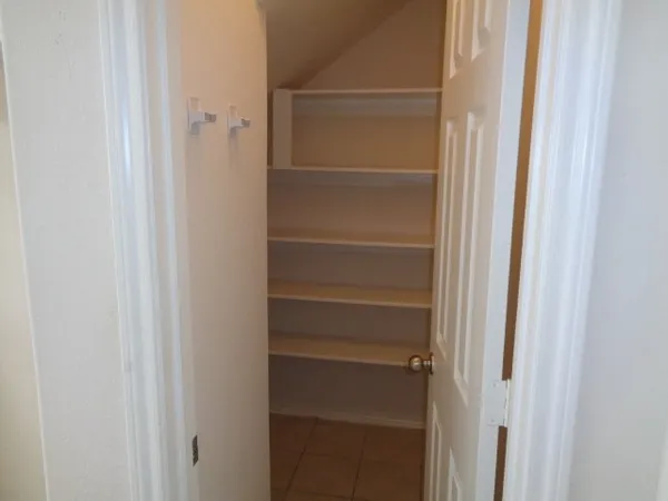 an empty room with white cabinet
