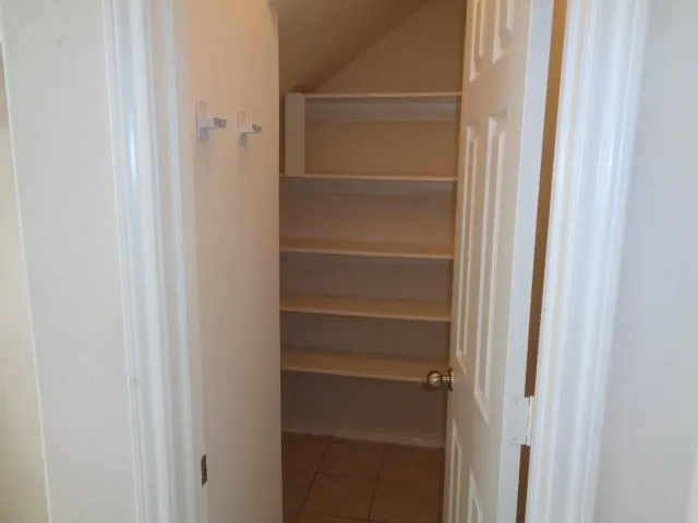 an empty room with white cabinet