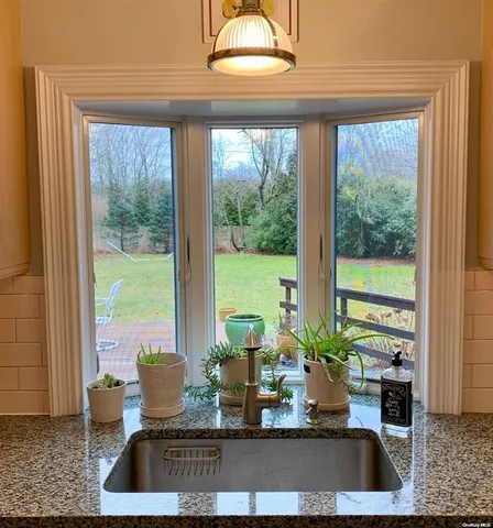 a view of living room with furniture and large windows