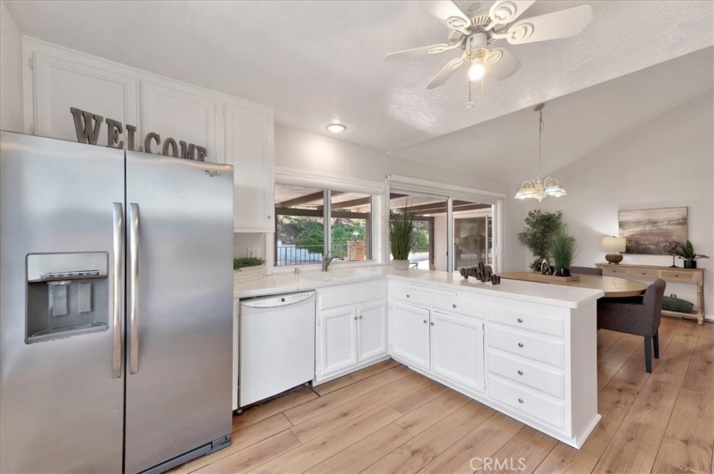 23772 Cll Hogar Mission Viejo, CA 92691 - Photo 12 of 30 a kitchen with white cabinets and stainless steel appliances