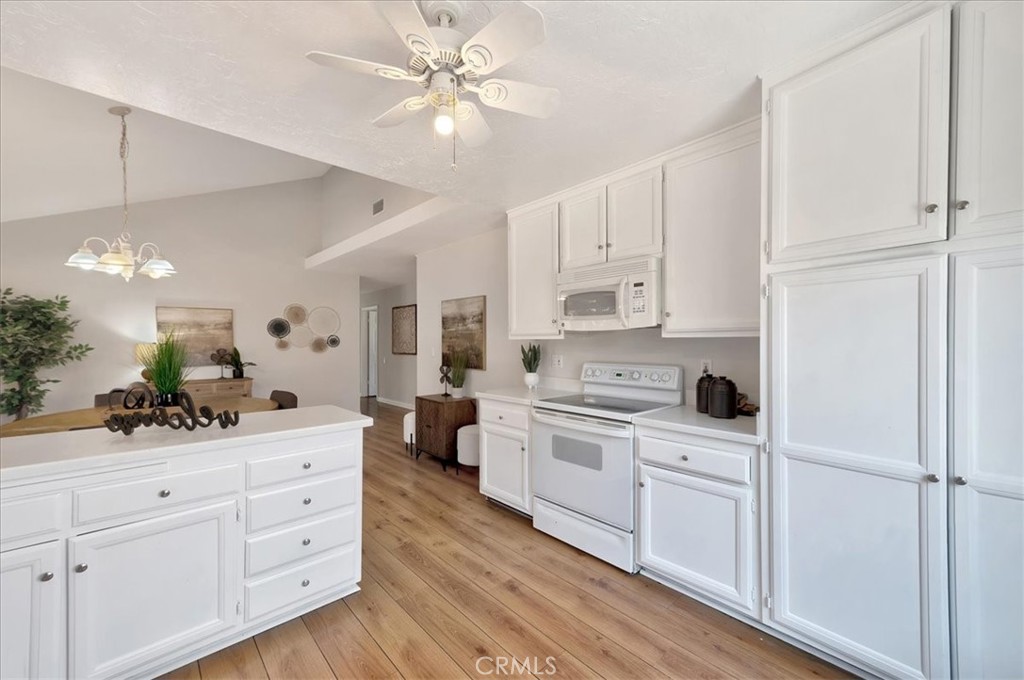 23772 Cll Hogar Mission Viejo, CA 92691 - Photo 13 of 30 a kitchen with white cabinets and white appliances