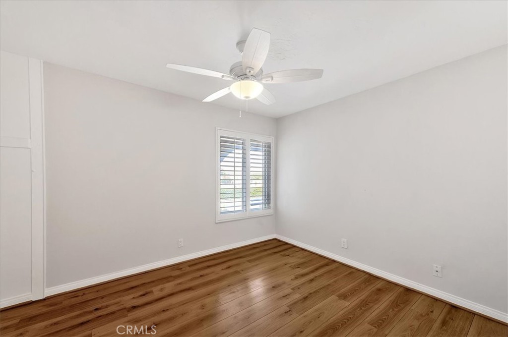 23772 Cll Hogar Mission Viejo, CA 92691 - Photo 15 of 30 an empty room with wooden floor fan and windows