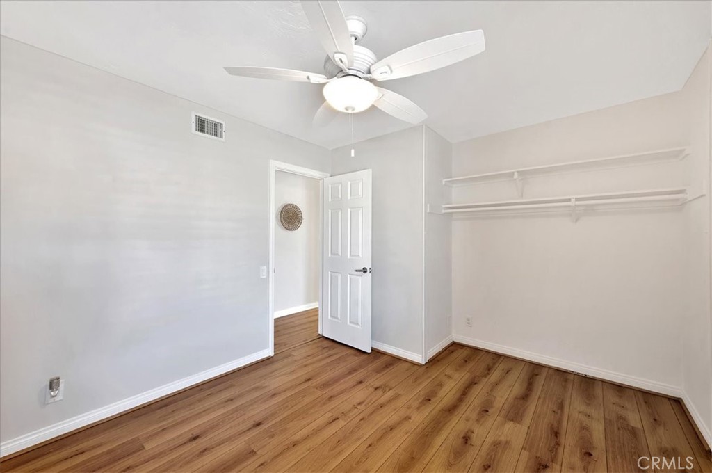 23772 Cll Hogar Mission Viejo, CA 92691 - Photo 16 of 30 an empty room with wooden floor and fan