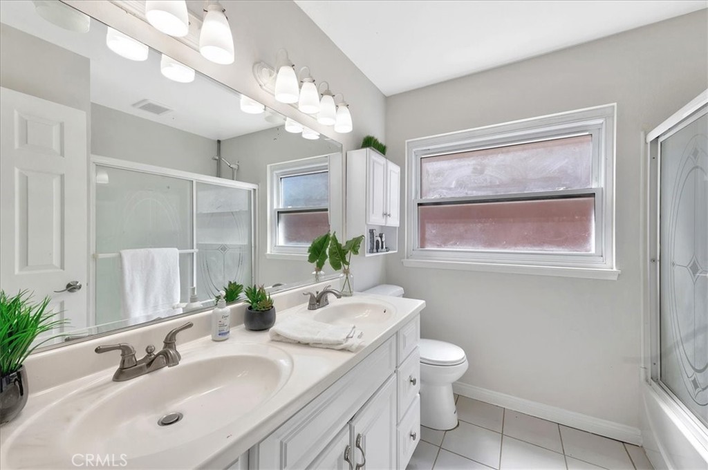 23772 Cll Hogar Mission Viejo, CA 92691 - Photo 21 of 30 a bathroom with a granite countertop sink a toilet and a mirror