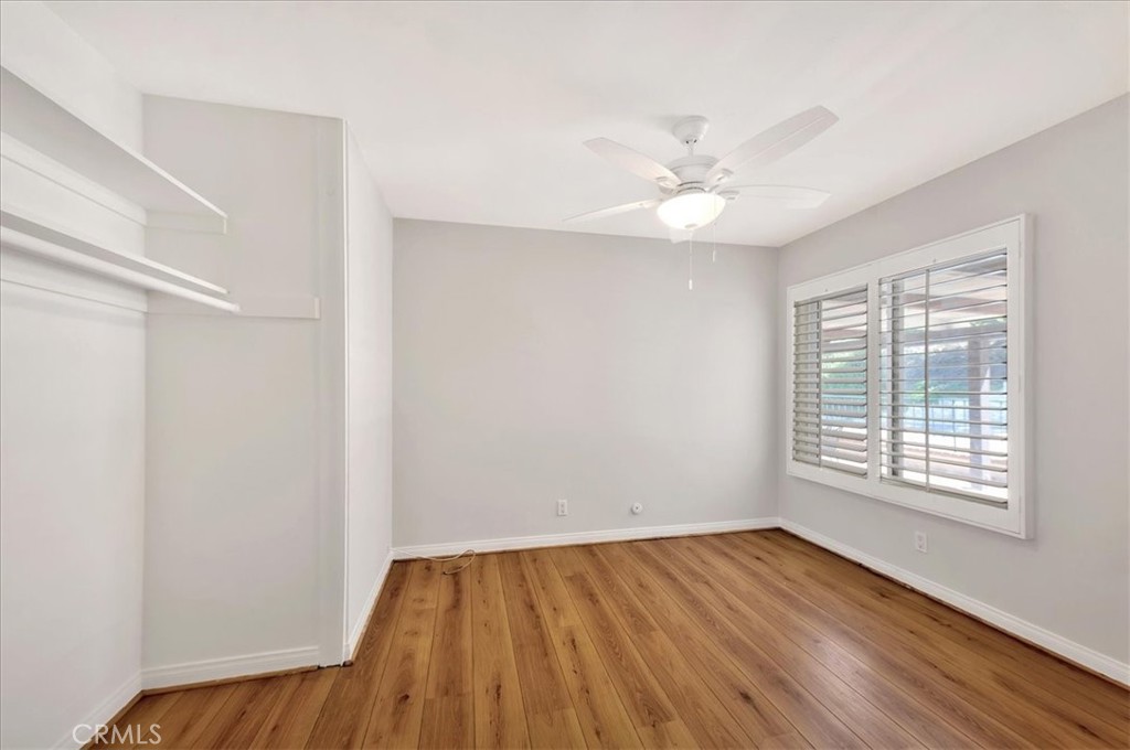 23772 Cll Hogar Mission Viejo, CA 92691 - Photo 26 of 30 an empty room with wooden floor and windows