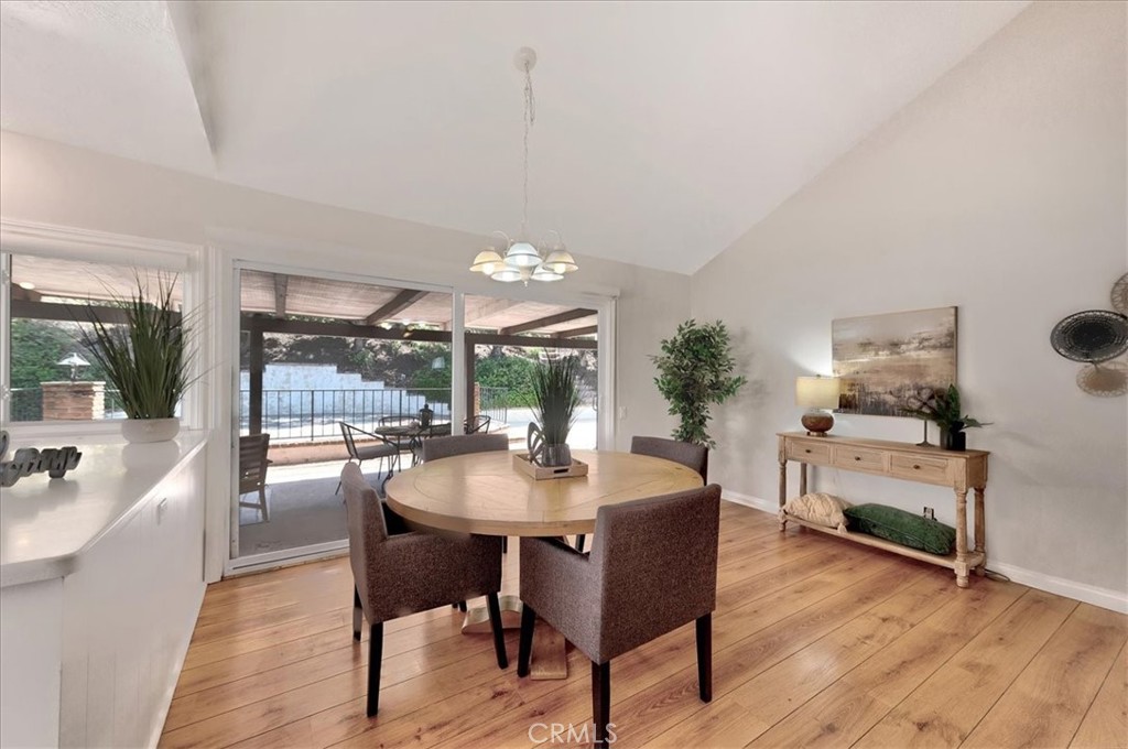 23772 Cll Hogar Mission Viejo, CA 92691 - Photo 9 of 30 a dining room with furniture a chandelier and wooden floor