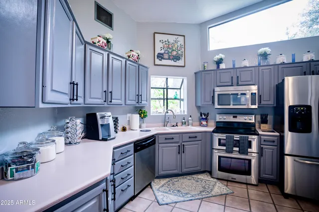 a kitchen with stainless steel appliances granite countertop a sink and cabinets