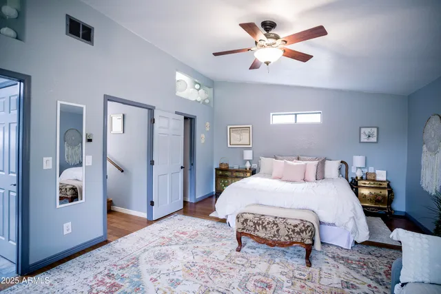 a living room with a bed and next to a window
