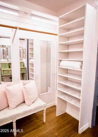 a bedroom with a bed flat screen tv and a window