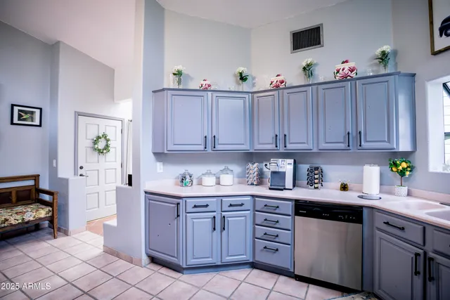 a kitchen with stainless steel appliances granite countertop a refrigerator sink and cabinets