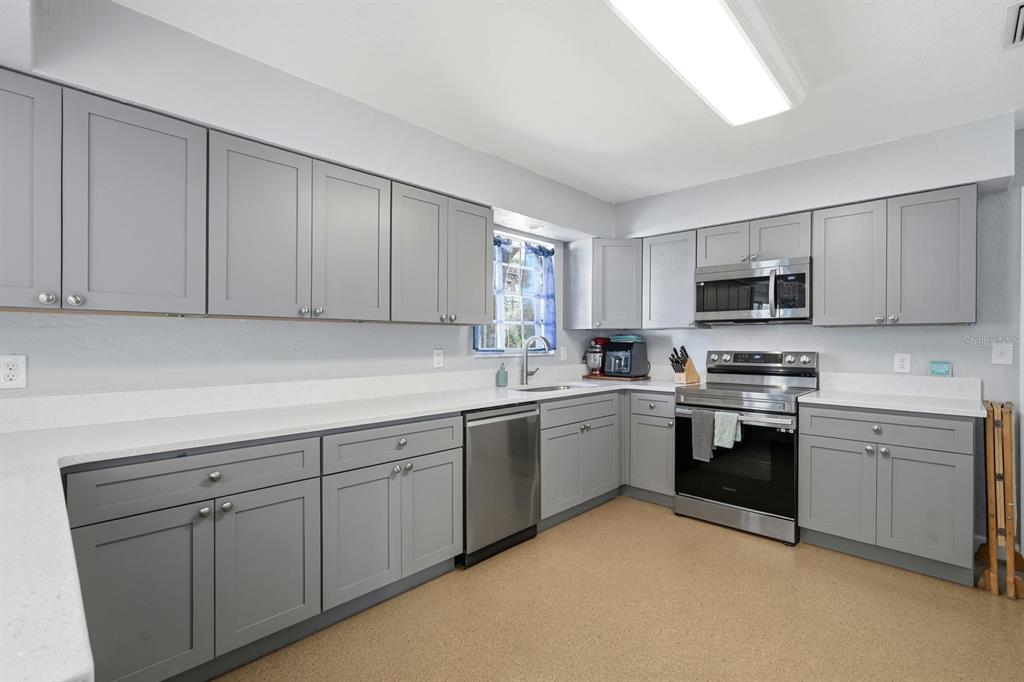 2329 Lime Tree Drive Edgewater, FL 32141 - Photo 8 of 22 a kitchen with sink cabinets and stainless steel appliances