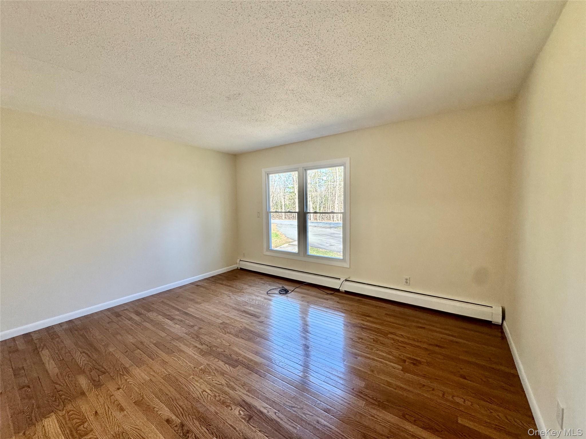 52 Boxbaum Road Sparrowbush, NY 12780 - Photo 17 of 23 a view of an empty room with wooden floor and a window