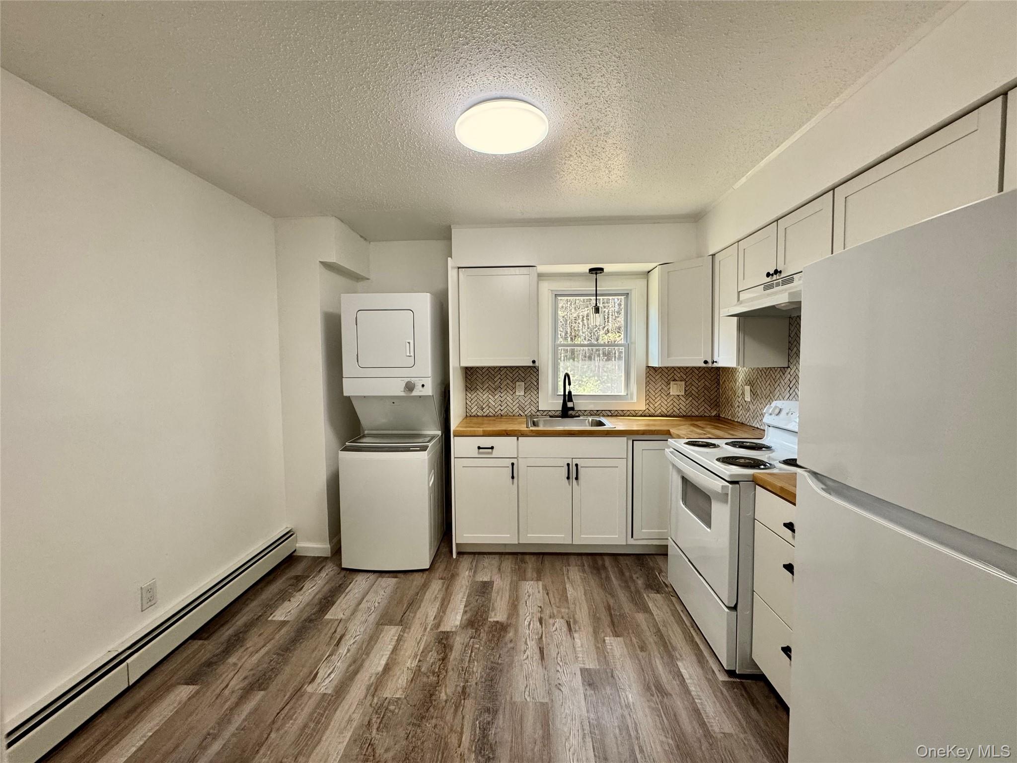 52 Boxbaum Road Sparrowbush, NY 12780 - Photo 5 of 23 a kitchen with a sink stove and refrigerator
