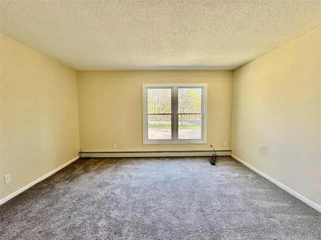 an empty room with a empty space and a window