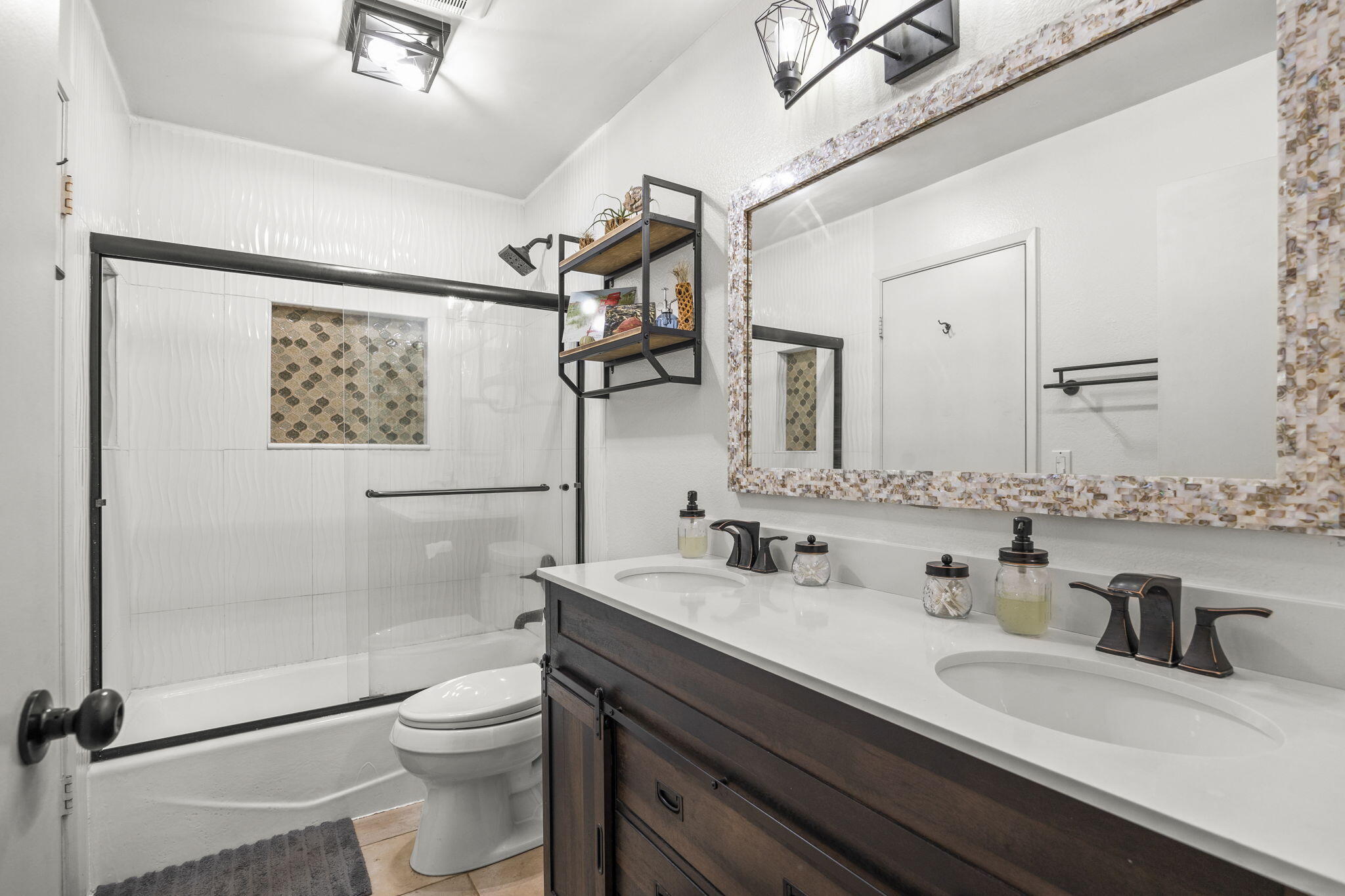4413 Catlin Circle, Unit B Carpinteria, CA 93013 - Photo 17 of 23 a bathroom with a granite countertop sink mirror vanity and toilet