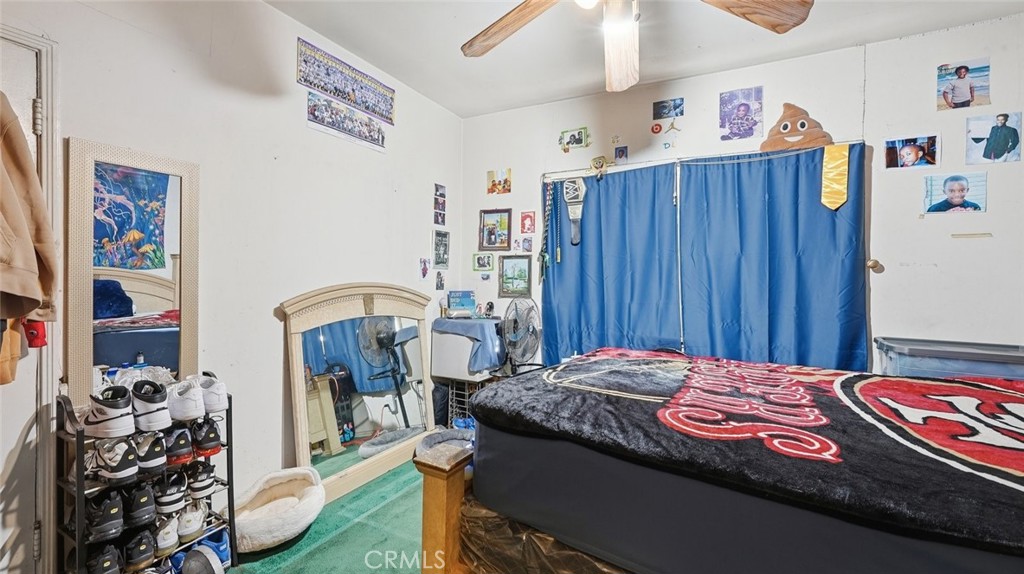 1523 East Vernon Avenue Los Angeles, CA 90011 - Photo 5 of 9 a bedroom with a bed and a dresser in it