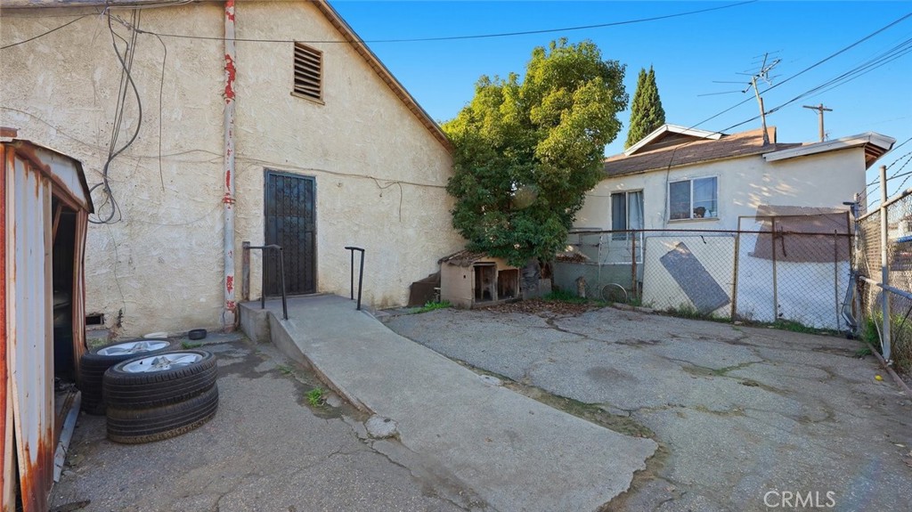 1523 East Vernon Avenue Los Angeles, CA 90011 - Photo 8 of 9 a view of a white house with a small yard and a large window