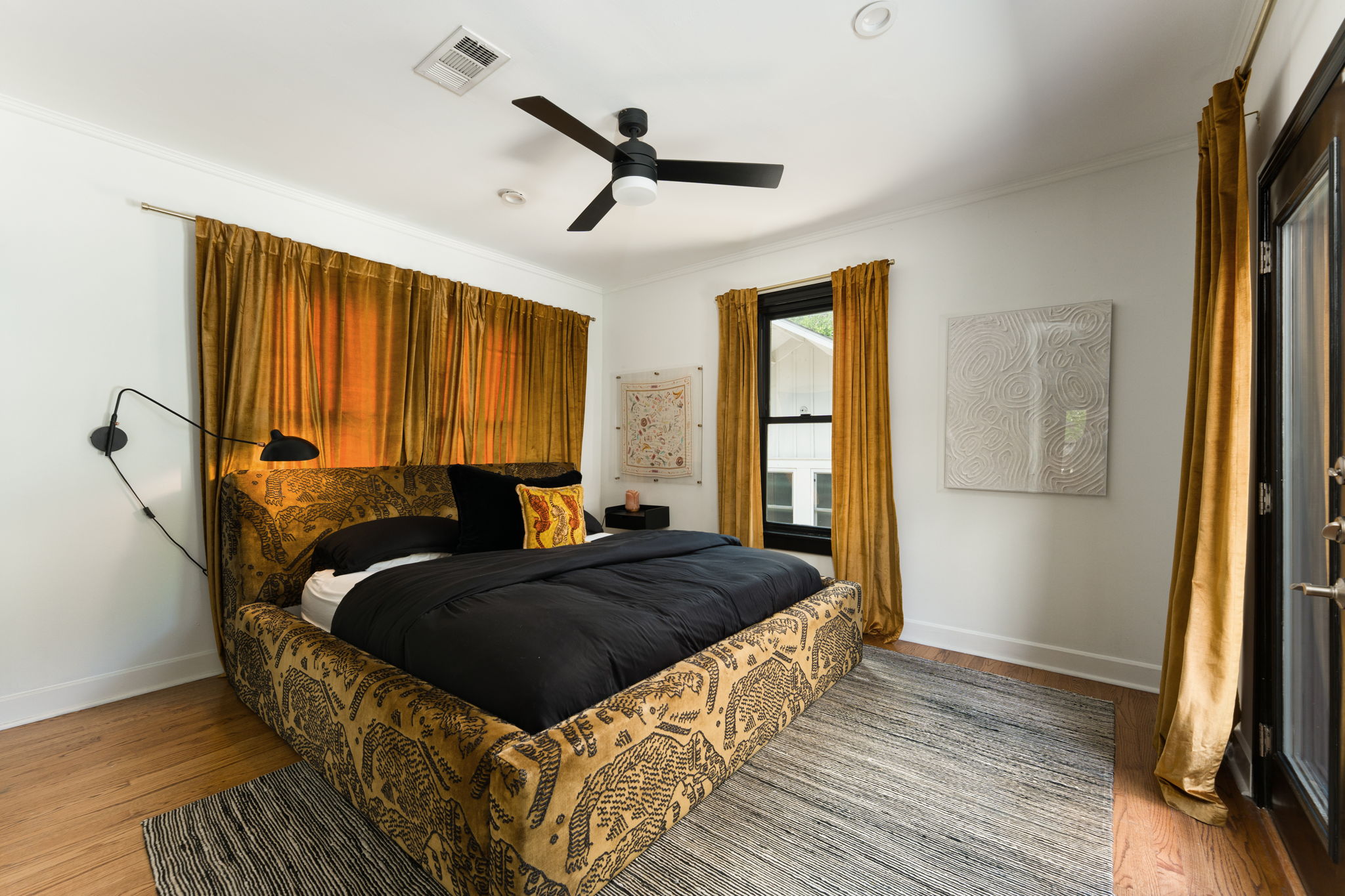 1704 Wethersfield Road Austin, TX 78703 - Photo 17 of 31 Bedroom featuring hardwood floors, a ceiling fan, and a glass-paneled door
