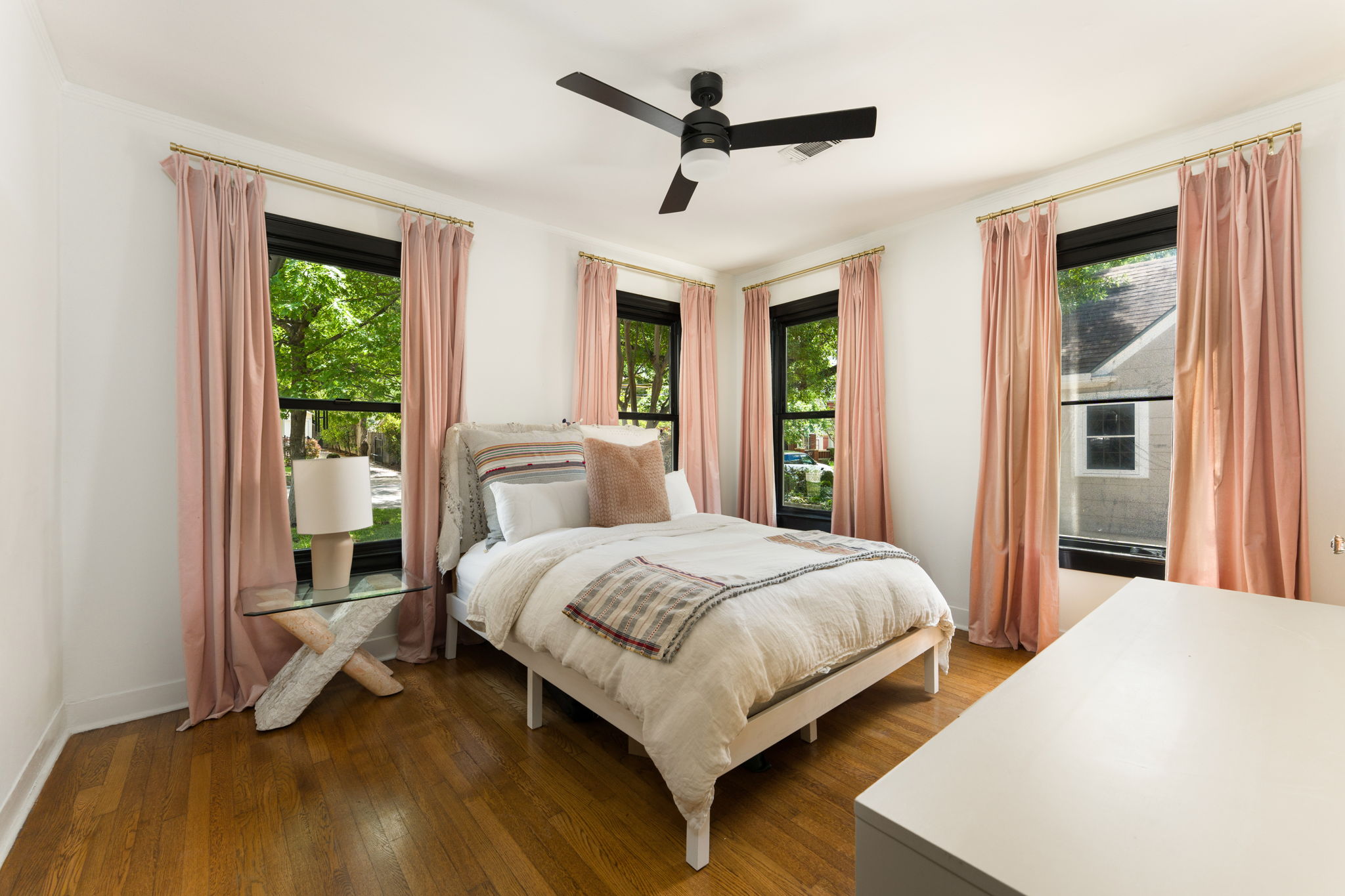 1704 Wethersfield Road Austin, TX 78703 - Photo 20 of 31 This room features rich hardwood flooring, a ceiling fan, and multiple windows with leafy green views