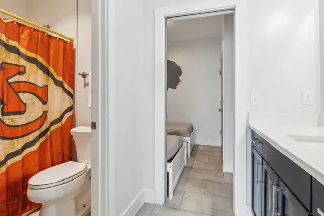 a kitchen with stainless steel appliances granite countertop a stove a sink a refrigerator and chairs