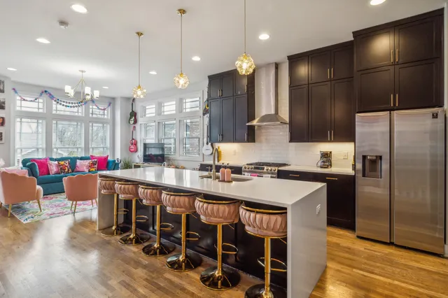 a kitchen with stainless steel appliances granite countertop a stove a sink dishwasher and a refrigerator