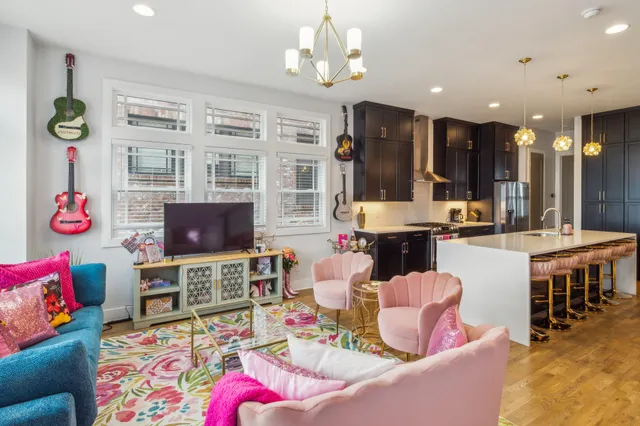 a bedroom with a large bed and a large mirror on the dresser