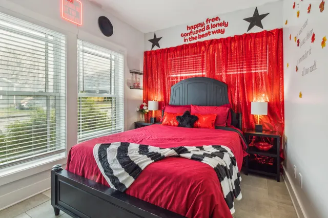 a bedroom with a bed and a painting on the wall