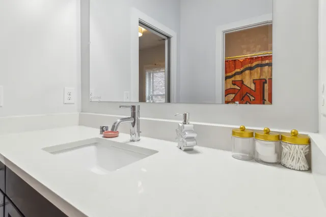 a bedroom with a bed lamp and a large window