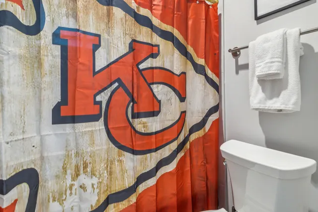 a bedroom with bed and a large window