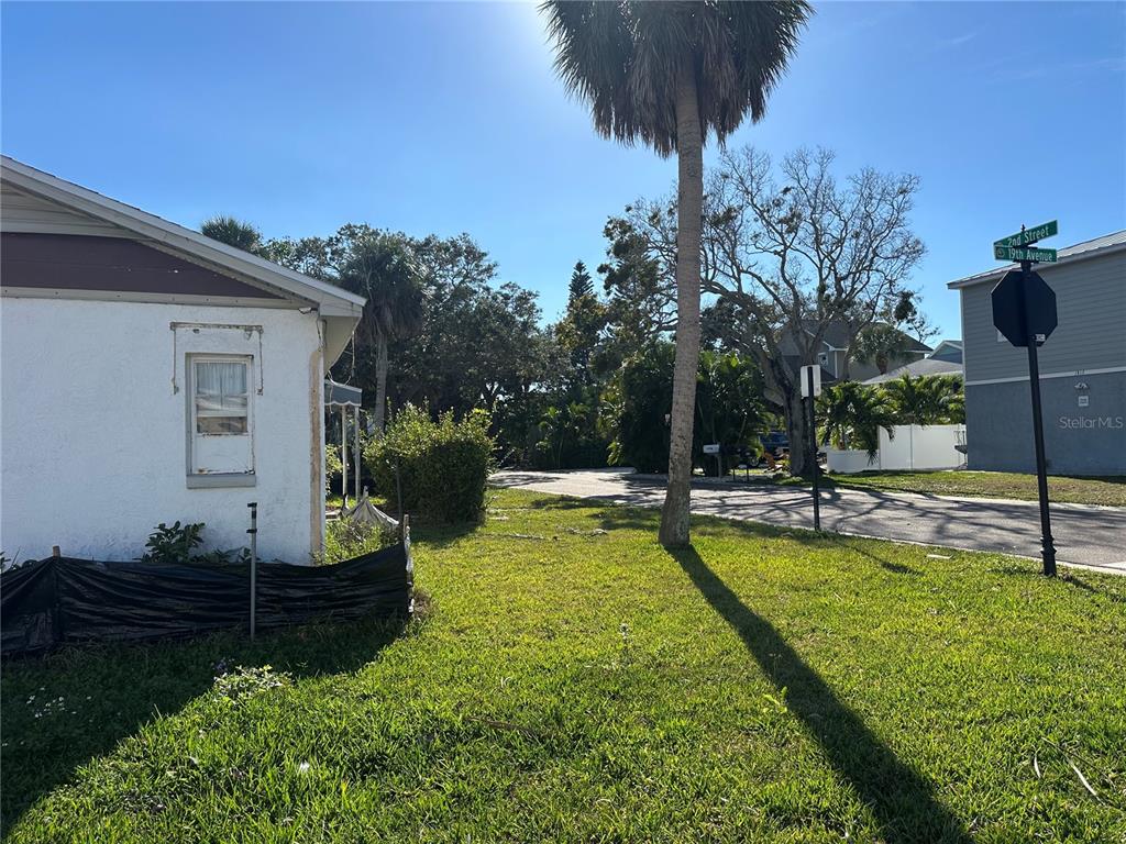 1811 2nd Street Indian Rocks Beach, FL 33785 - Photo 9 of 12 a view of a swimming pool with a garden