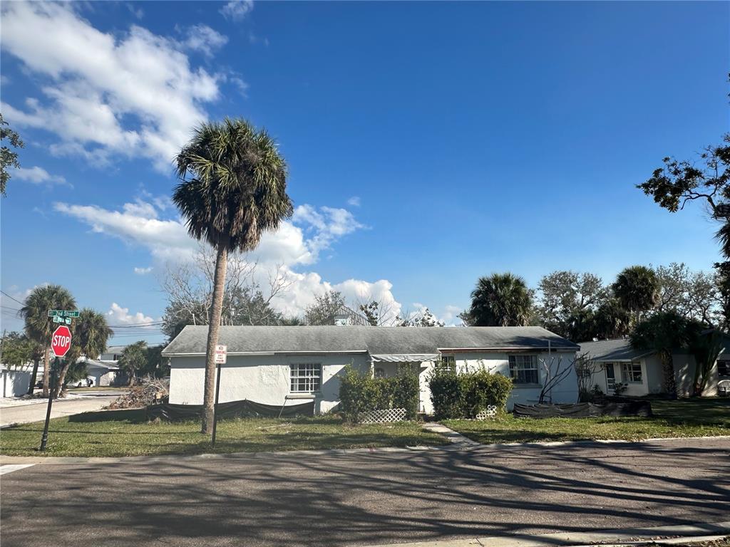 1811 2nd Street Indian Rocks Beach, FL 33785 - Photo 10 of 12 a front view of a house with a yard table and chairs