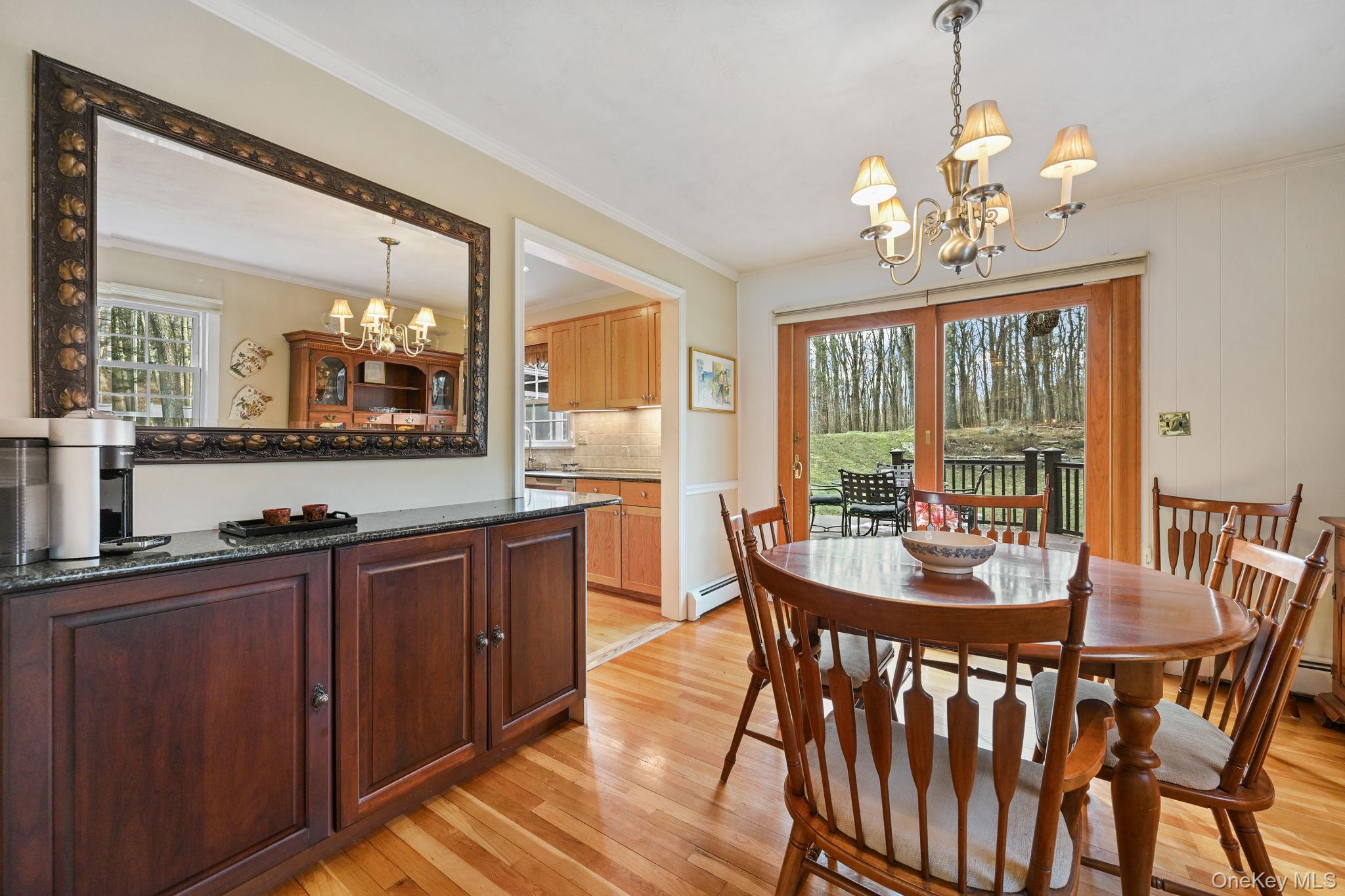 54 Lockwood Road South Salem, NY 10590 - Photo 12 of 46 a view of a dining room with furniture a chandelier and wooden floor