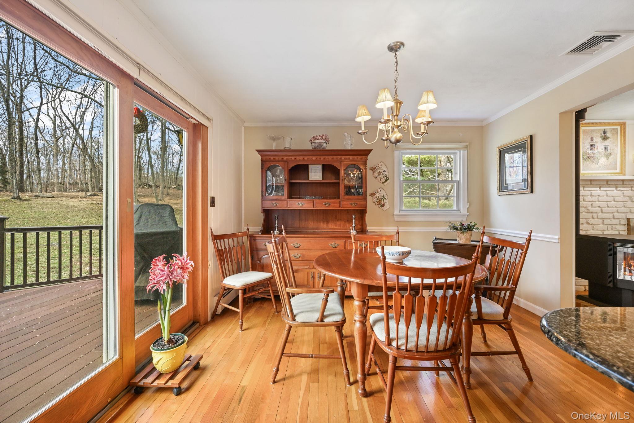 54 Lockwood Road South Salem, NY 10590 - Photo 13 of 46 a view of a dining room with furniture a chandelier and wooden floor