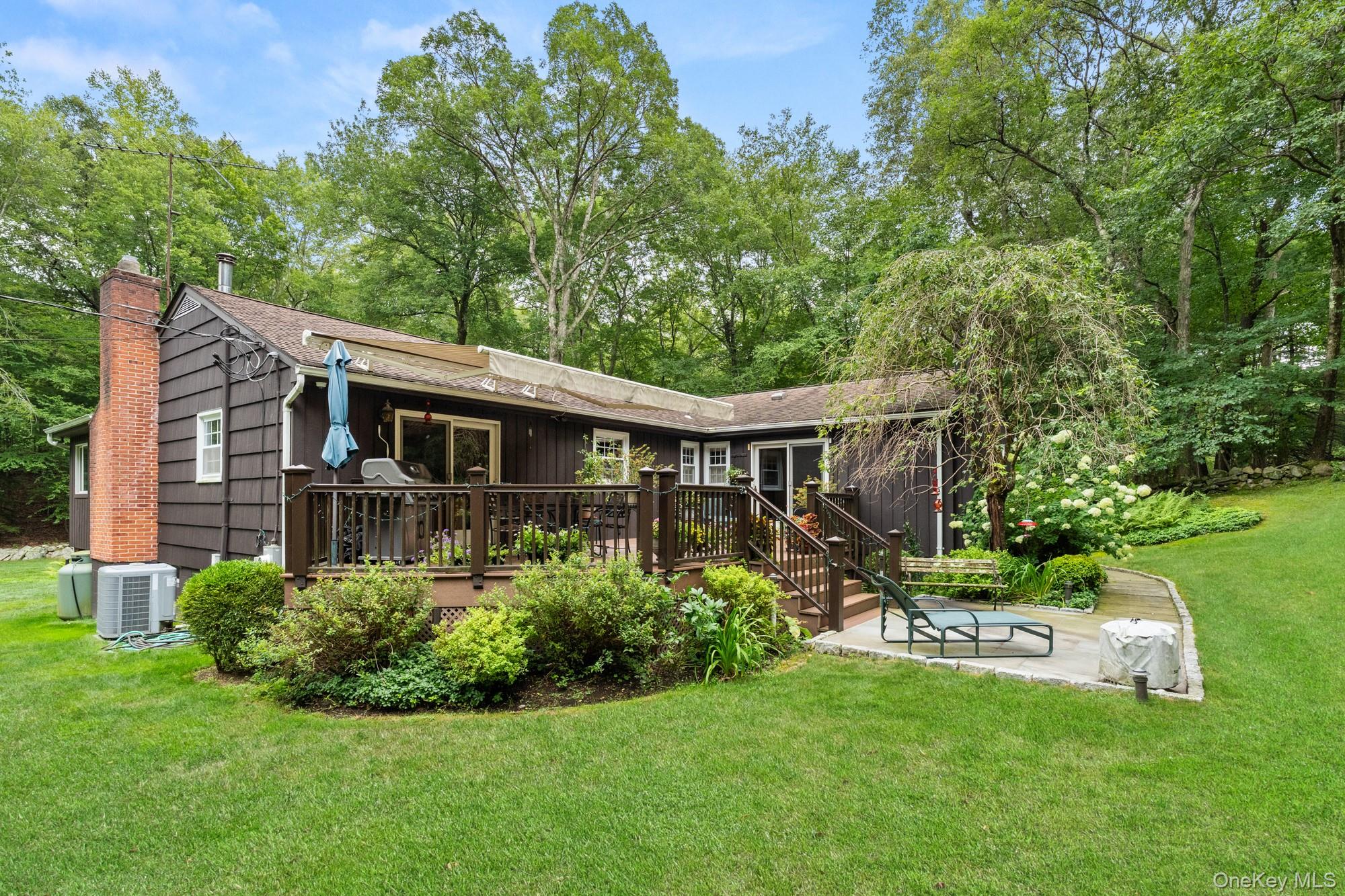 54 Lockwood Road South Salem, NY 10590 - Photo 40 of 46 a front view of a house with a yard table and chairs