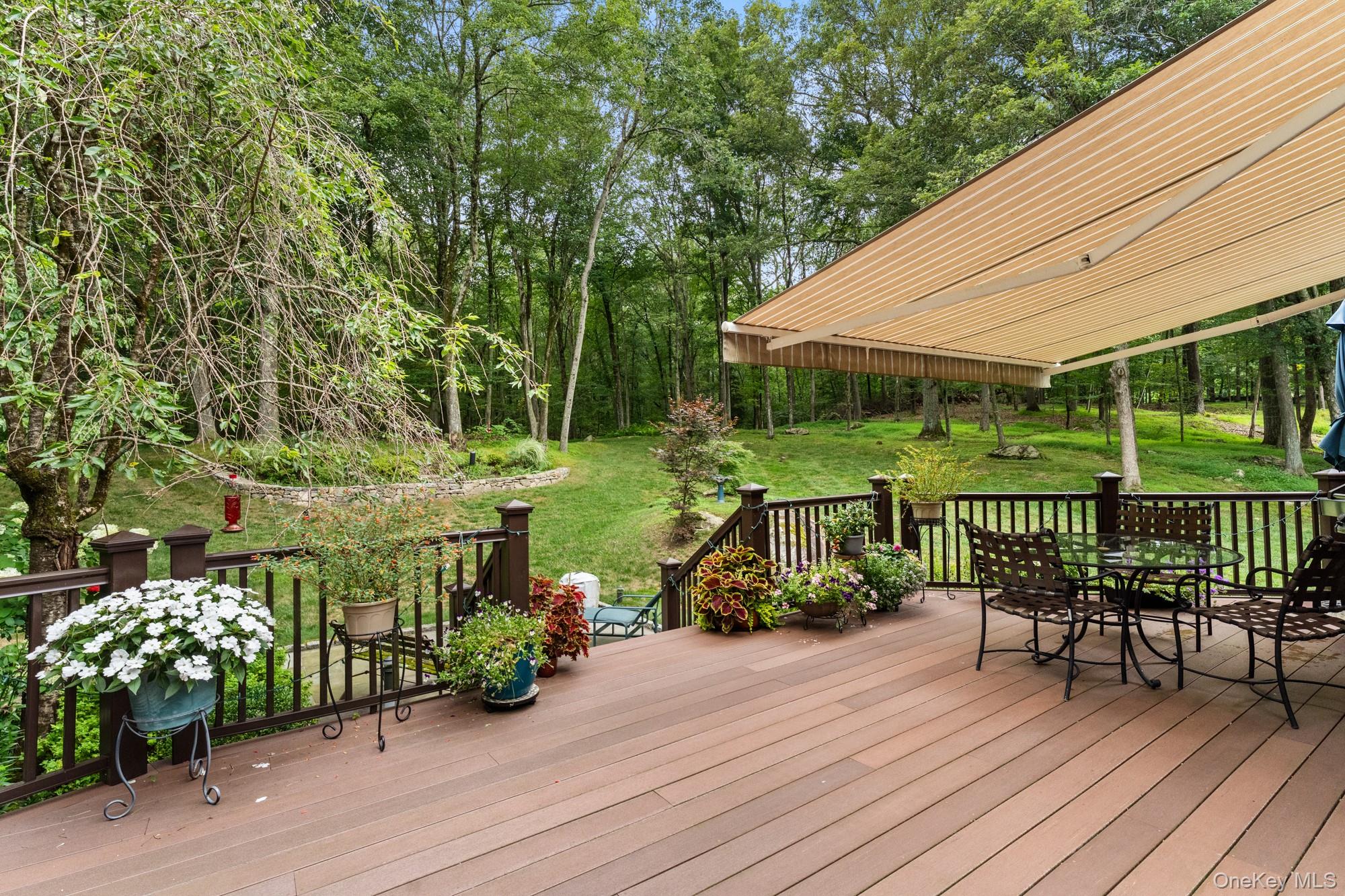 54 Lockwood Road South Salem, NY 10590 - Photo 42 of 46 a view of a table and chairs with wooden floor and fence
