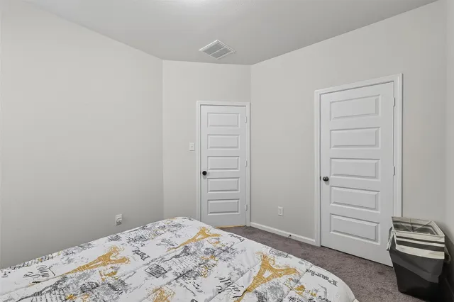 a bedroom with a bed and a closet