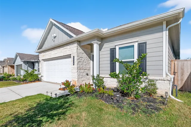 a view of a house with a small yard and a large window
