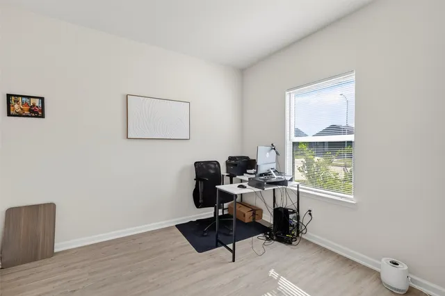 a work room with furniture and a window